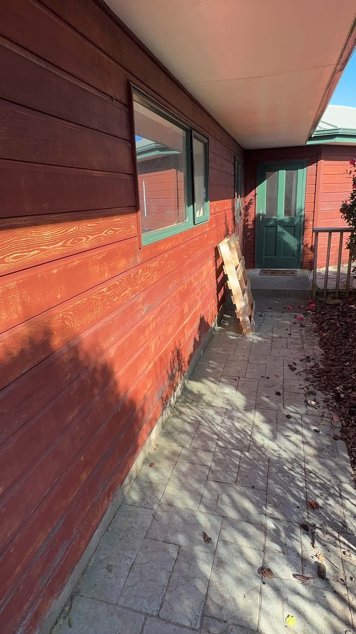 Before image of faded cedar cladding at a Johnsonville house.
