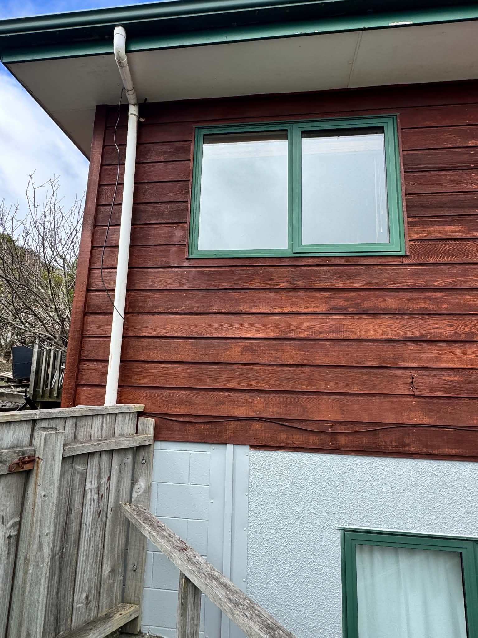 Completed cedar-restaining result at the standalone house.